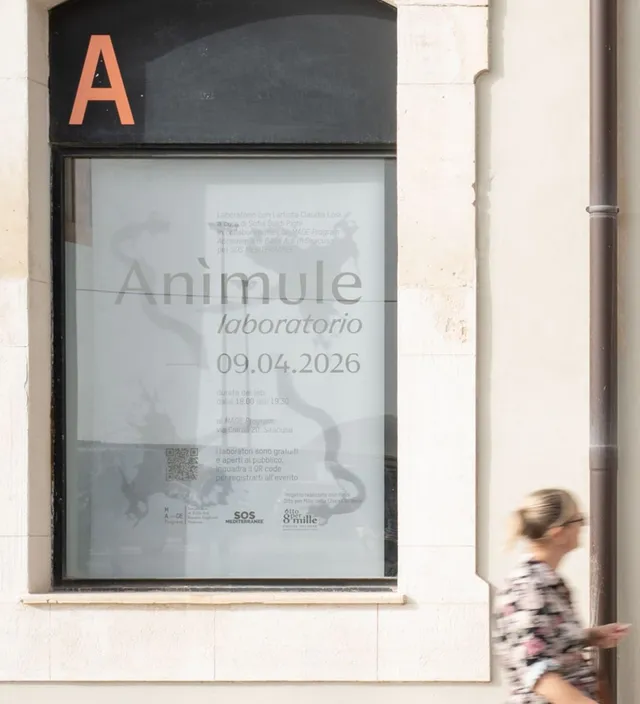 Anìmule poster in a window in Siracusa