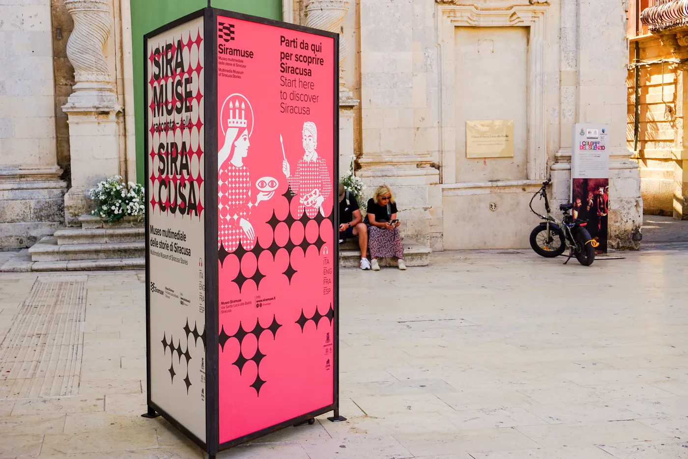 Pink Siramuse totem in front of a church